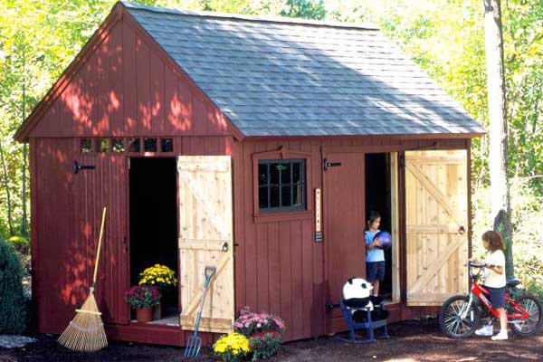 Red barn-style shed made from plywood siding with cedar trim and option of two double doors.